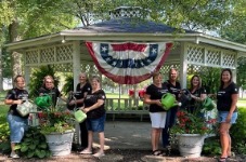 Arcanum Banking Center watering flowers at Ivester Park